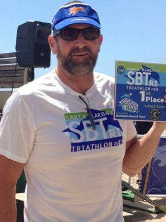 Hypercat athlete holds up 1st place award Santa Barbara Aquabike
