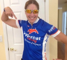 Female athlete points to her new Hypercat cycling jersey